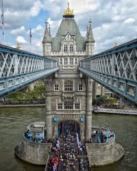 View of bridge over river against cloudy sky