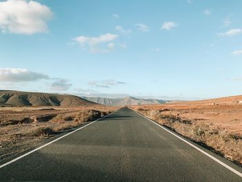 Empty road along landscape