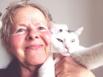 Portrait of woman with cat at home