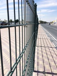 Road in city against cloudy sky