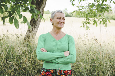 Portrait of young woman standing on field