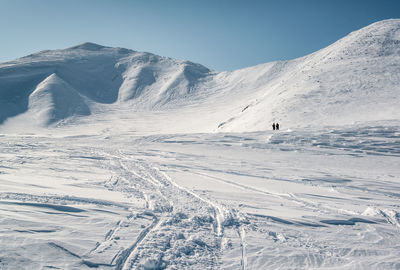 Scenic view of snow covered mountains against sky