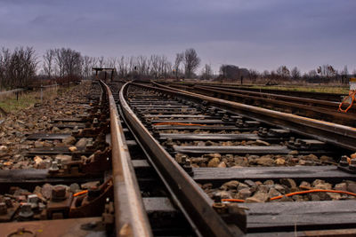 Railroad tracks by train against sky