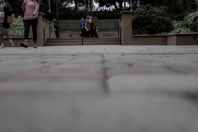 Full length of woman walking on footpath