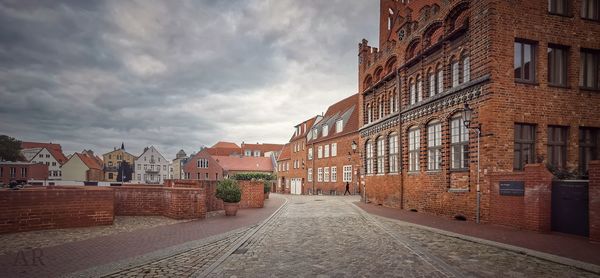 Street amidst buildings against sky