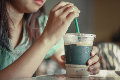 Midsection of man drinking coffee cup