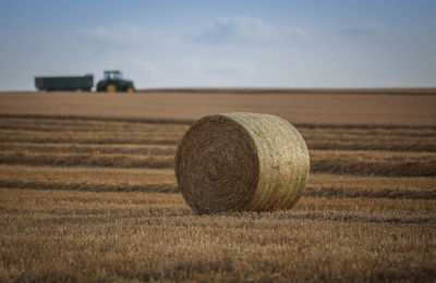Hay bale in field against the sky