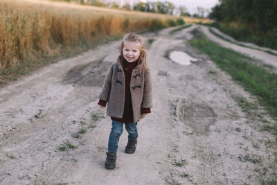 Portrait of girl standing on road