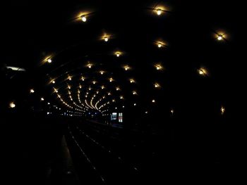 Illuminated tunnel at night