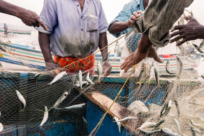 Close-up of fishermen with  net