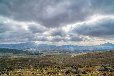 Scenic view of mountains against cloudy sky