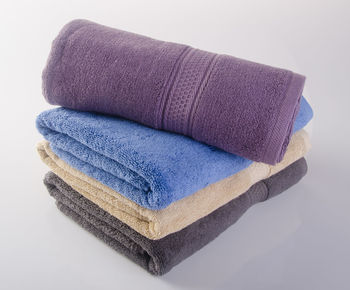 Close-up of stacked towels over white background