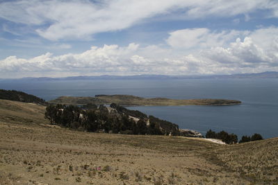 Scenic view of sea and mountains against sky