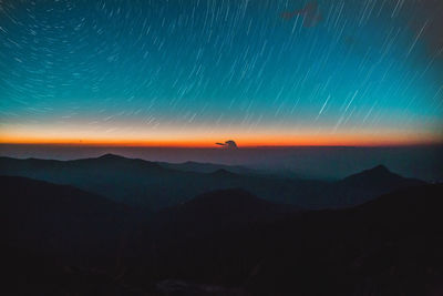 Scenic view of mountains against sky at night