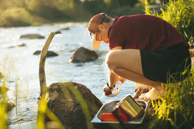 Young man at camping at lakeside