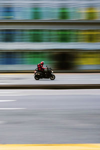 Blurred motion of people riding motorcycle