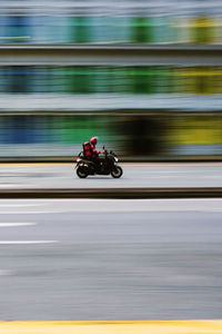Blurred motion of people riding motorcycle