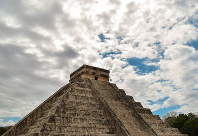 Low angle view of temple against cloudy sky