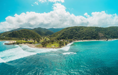 Scenic view of sea and mountains against sky