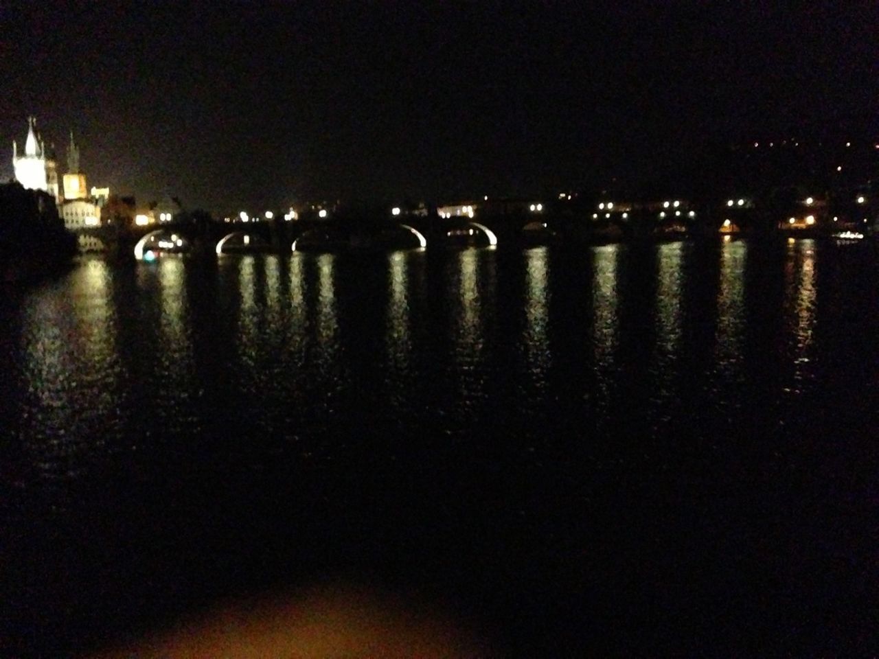 water, night, illuminated, reflection, waterfront, sea, river, built structure, architecture, clear sky, copy space, outdoors, no people, building exterior, city, sky, nature, bridge - man made structure, dark, tranquility