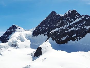 Scenic view of snow covered mountains against sky