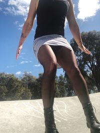 Low section of woman against sky