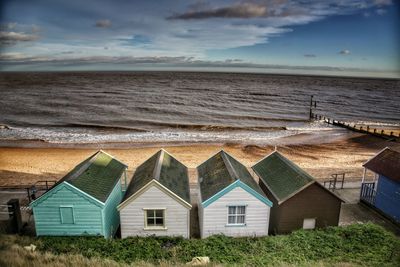 Houses on beach against sky