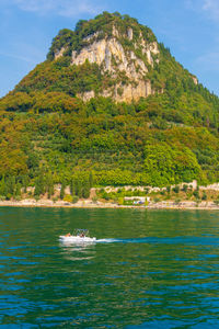 Scenic view of sea and mountains against sky