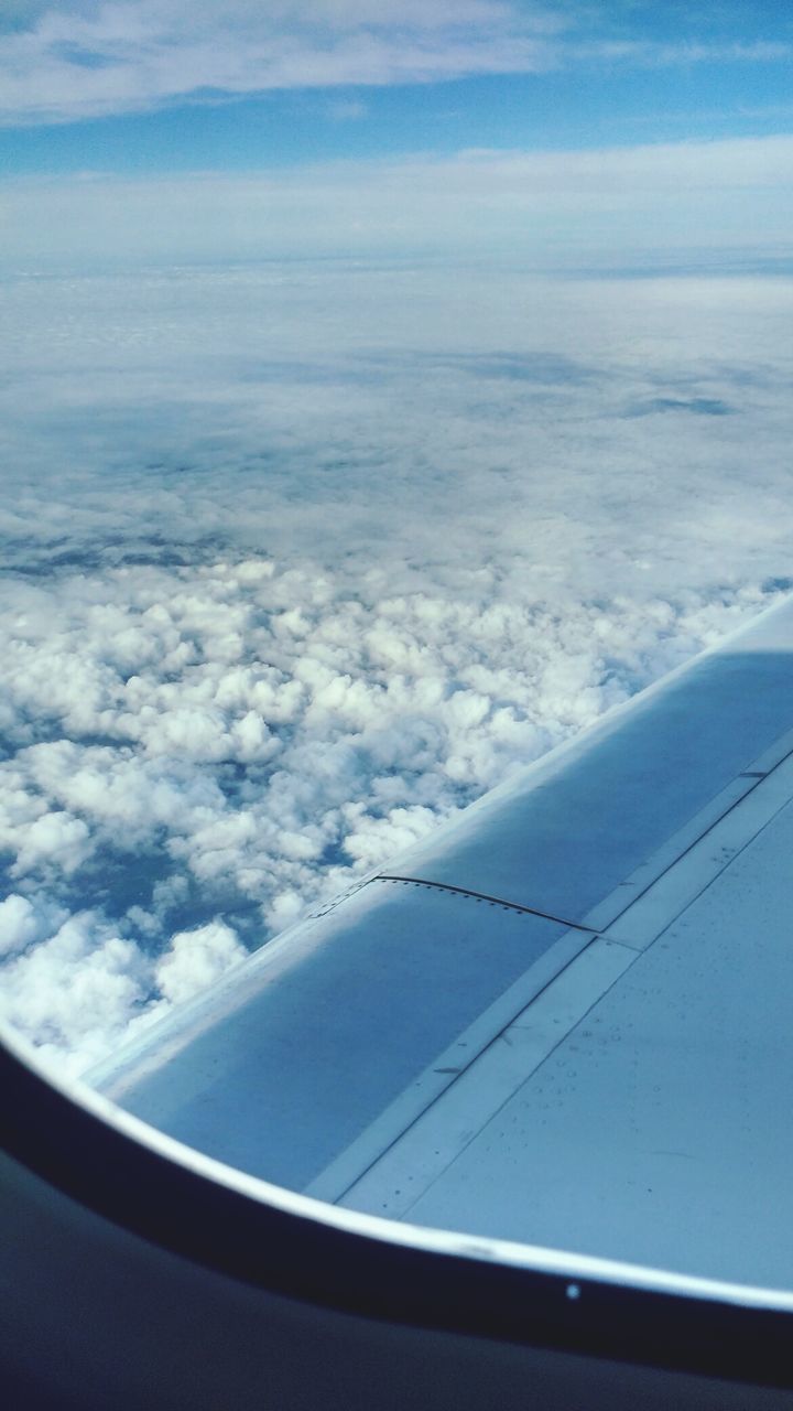 airplane, journey, aerial view, airplane wing, transportation, beauty in nature, cloudscape, cloud - sky, sky, flying, travel, nature, air vehicle, scenics, no people, tranquil scene, mid-air, mode of transport, tranquility, aircraft wing, window, day, the natural world, blue, sky only, outdoors, vehicle part, close-up