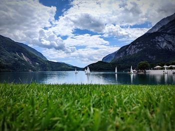 Scenic view of lake by mountains against sky