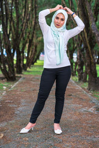 Full length portrait of woman standing outdoors