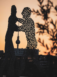 Silhouette of building against sky during sunset