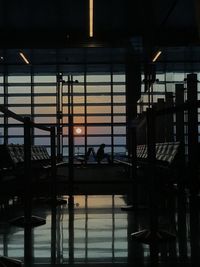 Reflection of silhouette people on glass of building