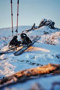 People skiing on snowcapped mountain against sky