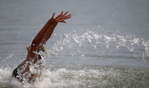 Man splashing water in sea