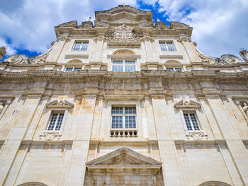 Low angle view of historical building against cloudy sky