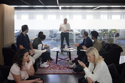 Group of business people having meeting in lobby