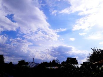 Silhouette of trees against cloudy sky