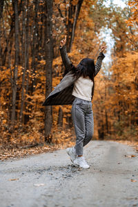 Autumn anxiety, mental health. happy brunette woman enjoy life in autumn forest
