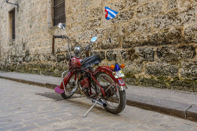 Bicycle parked on street against building