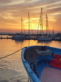 Sailboats in marina at sunset