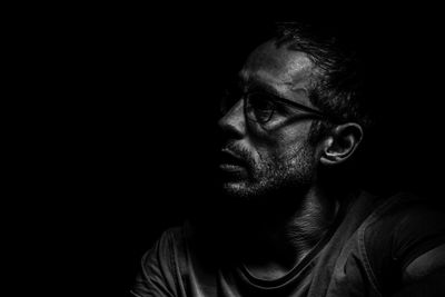Close-up of man against black background
