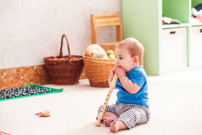 Cute baby girl sitting in basket