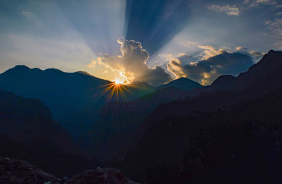 Scenic view of silhouette mountains against sky at sunset
