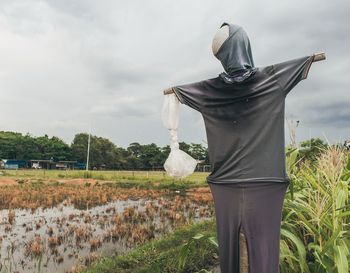 View of the scarecrow on the field against the sky