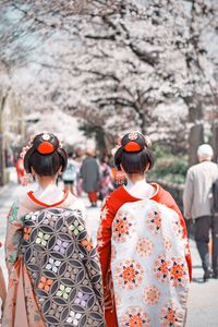 Rear view of females walking outdoors