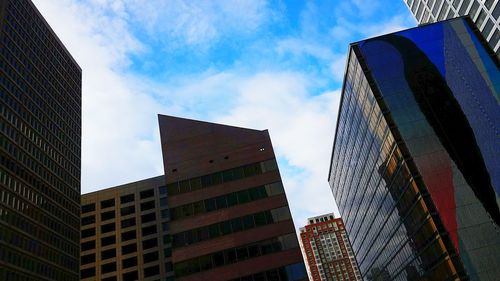 Low angle view of modern buildings against sky in city