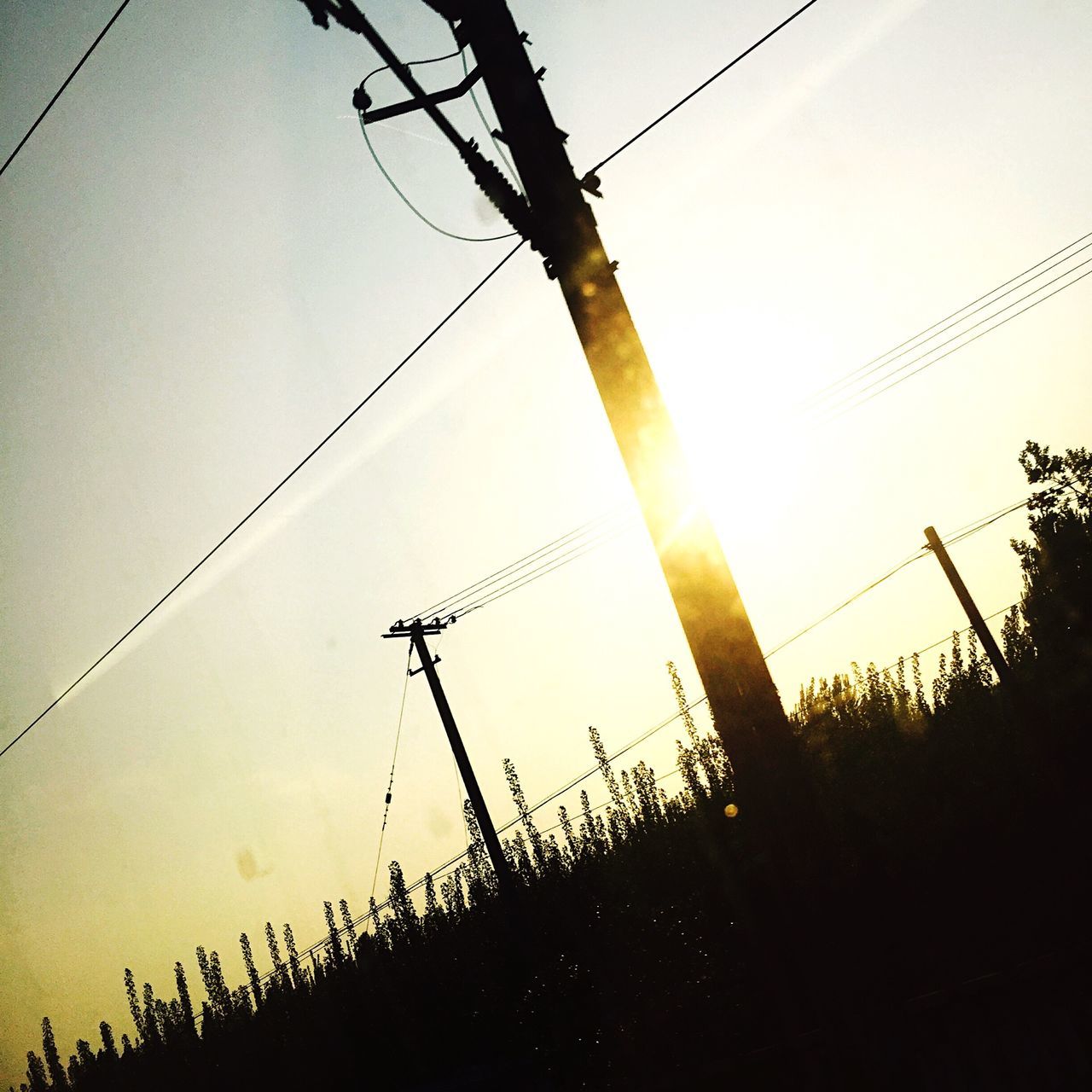 power line, electricity pylon, power supply, low angle view, electricity, silhouette, fuel and power generation, cable, connection, clear sky, technology, sunset, sky, power cable, dusk, complexity, outdoors, nature, no people, day