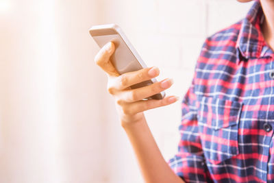 Midsection of woman using smart phone