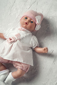 Cute girl holding toy against wall at home